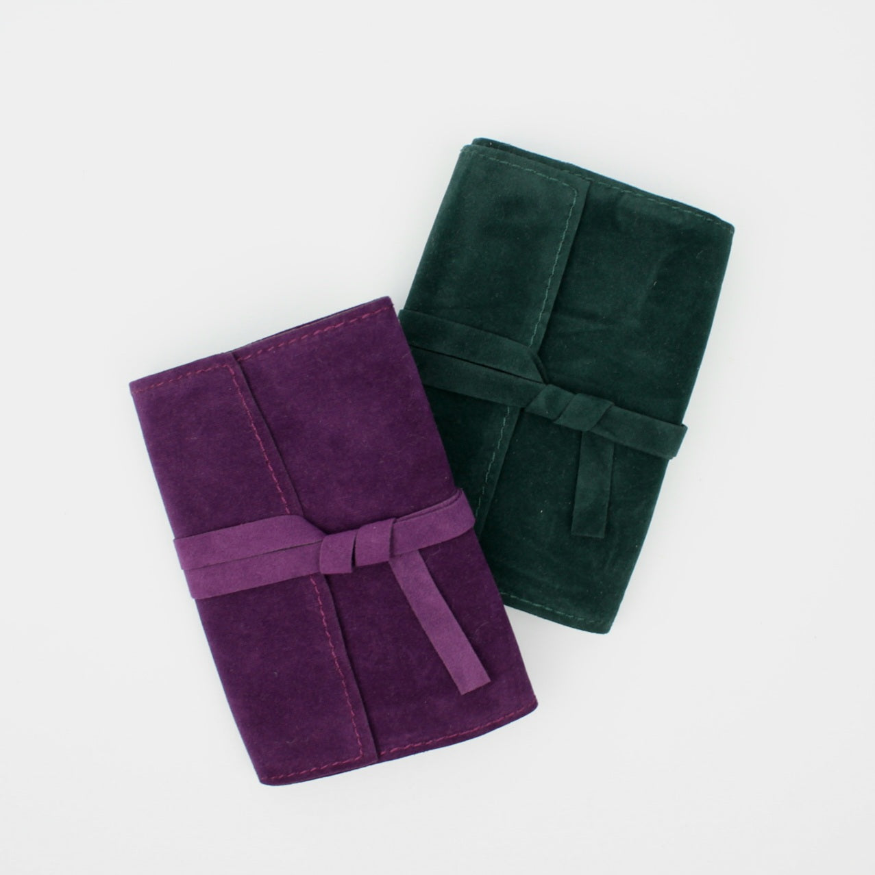Dwa aksamitne futerały na karty tarota - ciemnozielony i fioletowy - ułożone obok siebie